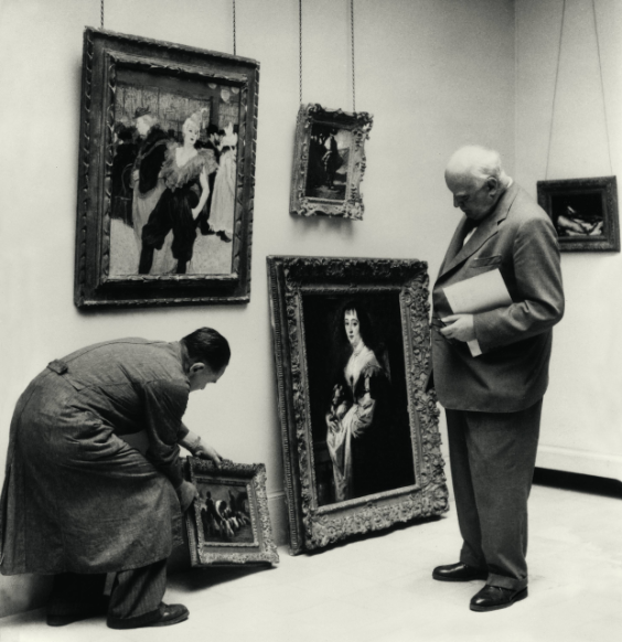 Oskar Reinhart rehanging his collection, assisted by his chauffeur Albert Fritschi, 1955